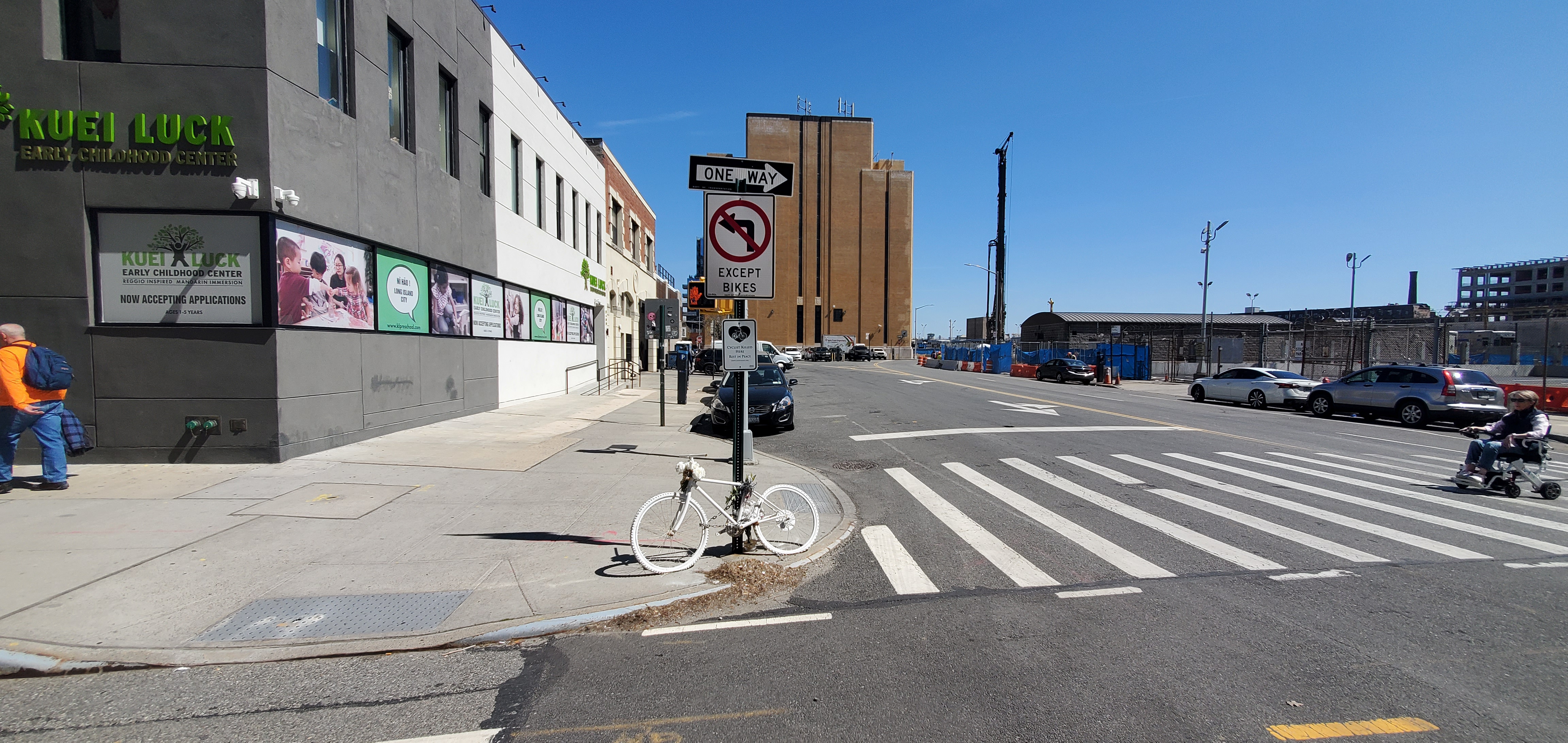 White bike and plaque attached to street sign